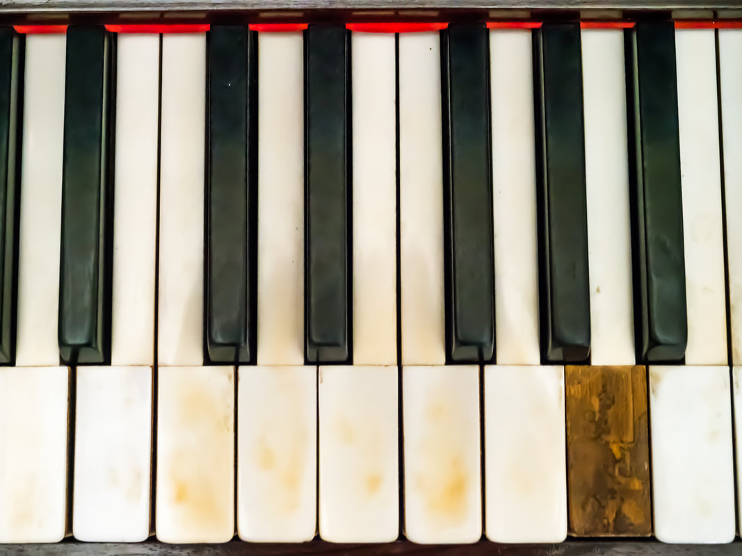 Vintage piano. Yellowed and broken piano keys.