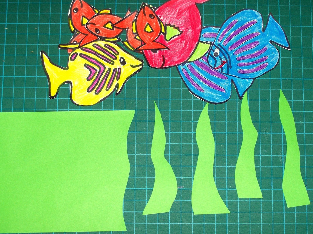 3. Cut out the fish, and also cut out some seaweed shapes from the piece of green paper.