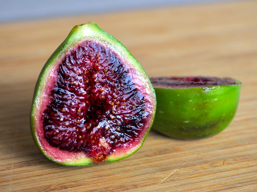 Photo of fig. Ripe, red and succulent, cut in half. 
