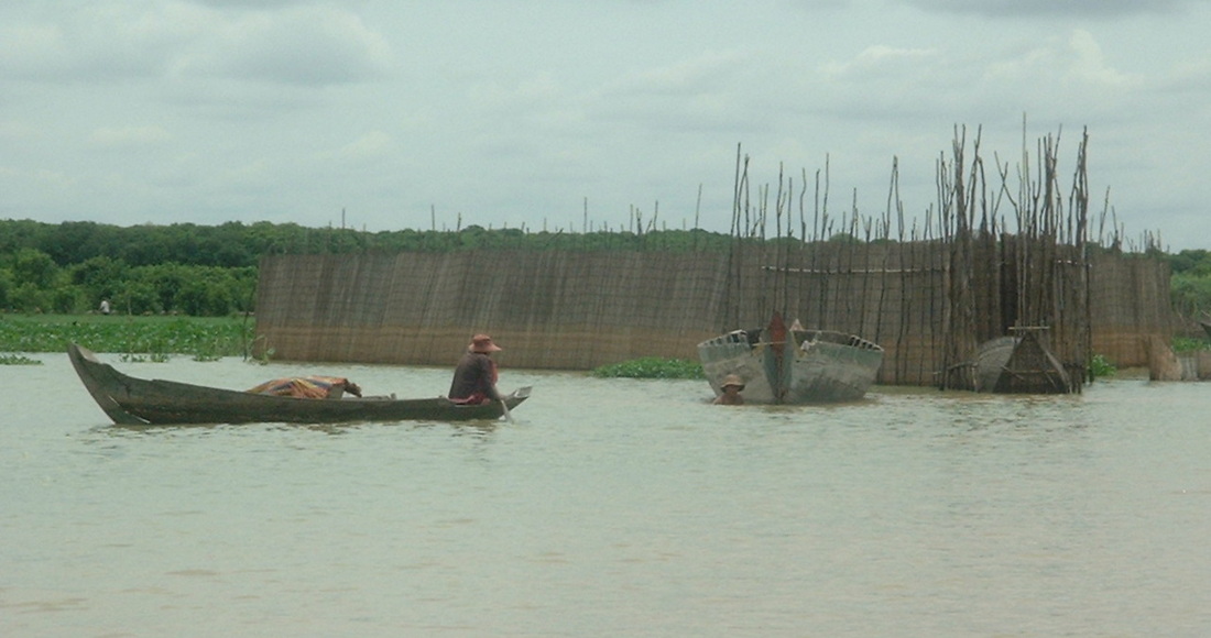 Fishing on the Tonlé Sap Lake near Siem Reap, Cambodia. Fishermen using a fish trap.