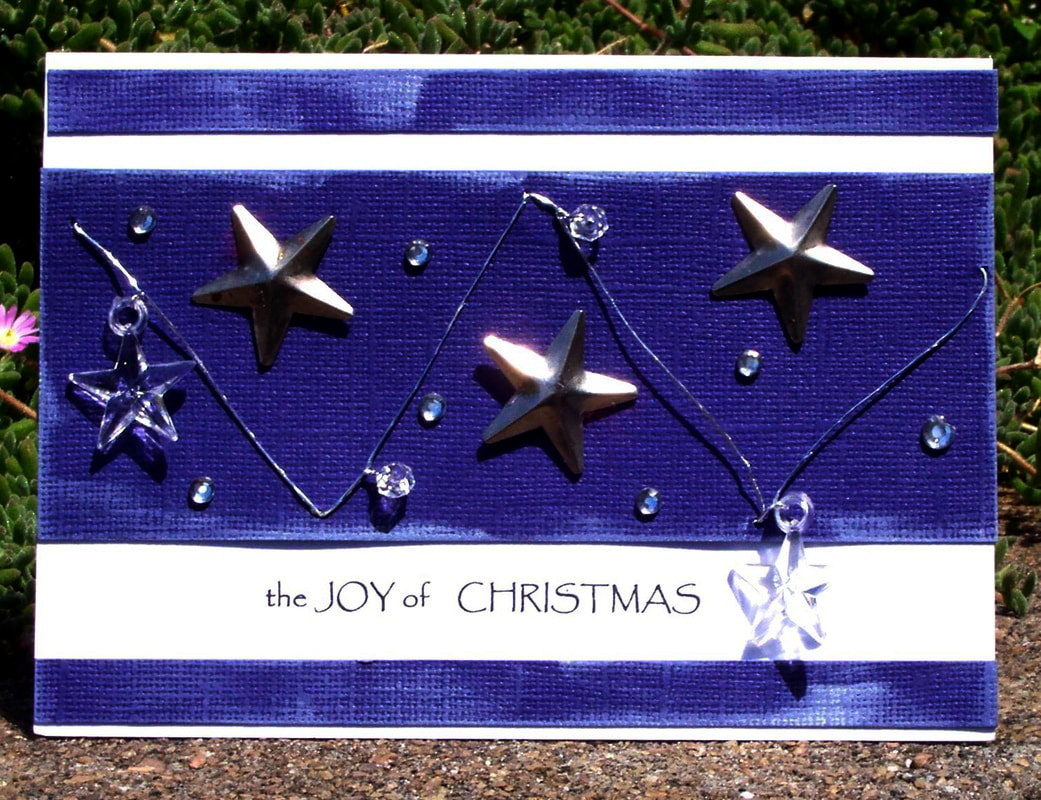 Instructions on how to make this Christmas card with stars and wording the joy of christmas