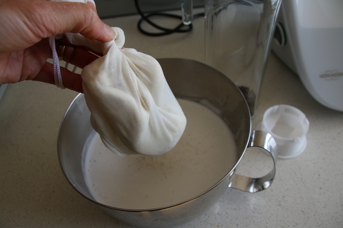 Draining Almond Milk using a nut bag.
