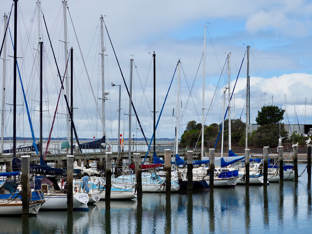Hastings Jetty, Mornington Peninsula, Victoria, Australia. Moored boats, ocean, beach, pylons.