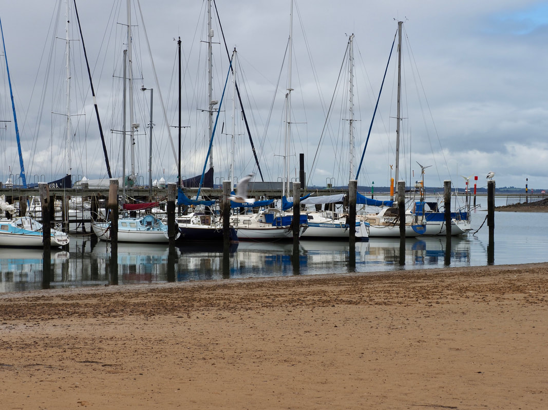 Hastings Jetty, Mornington Peninsula, Victoria, Australia. Moored boats, ocean, beach, pylons.