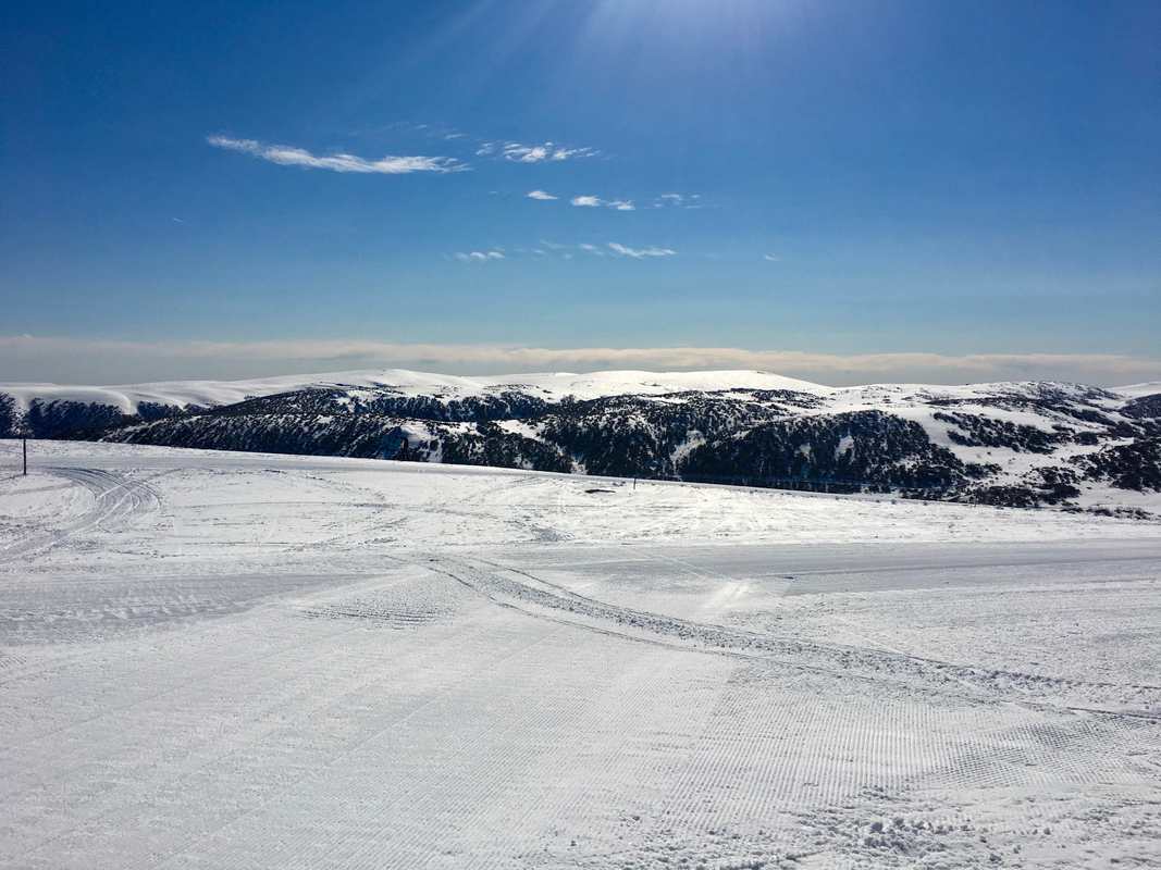 Falls Creek Ski Fields in winter. Snow, blue sky.