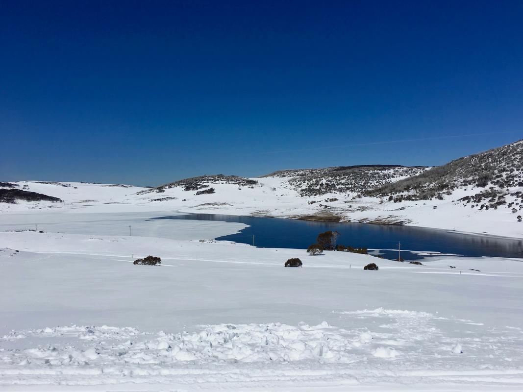 Falls Creek Ski Fields in winter. Snow, blue sky.